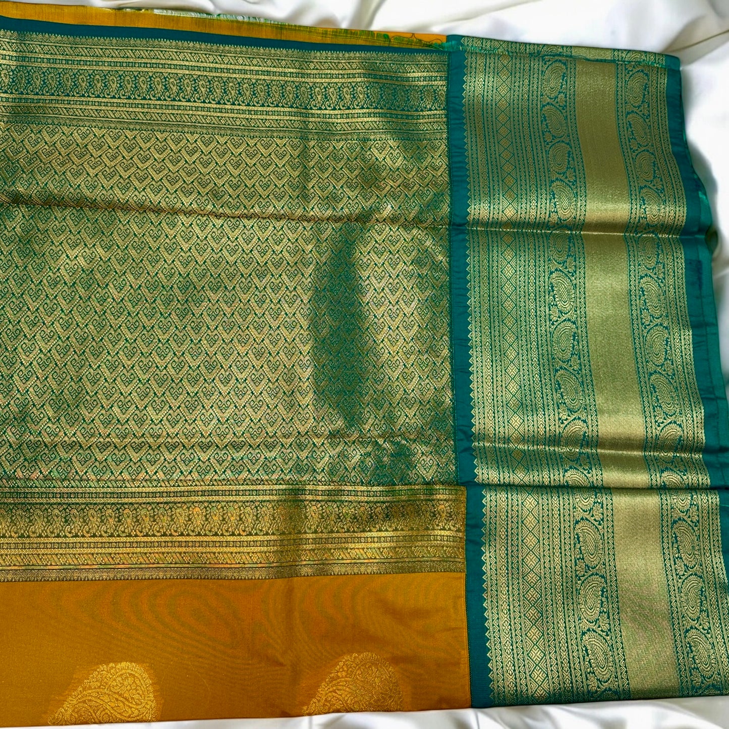 SEMI SILK SAREE – DARK YELLOW WITH SOLID PATTERN AND GREEN BIG GOLDEN BORDER