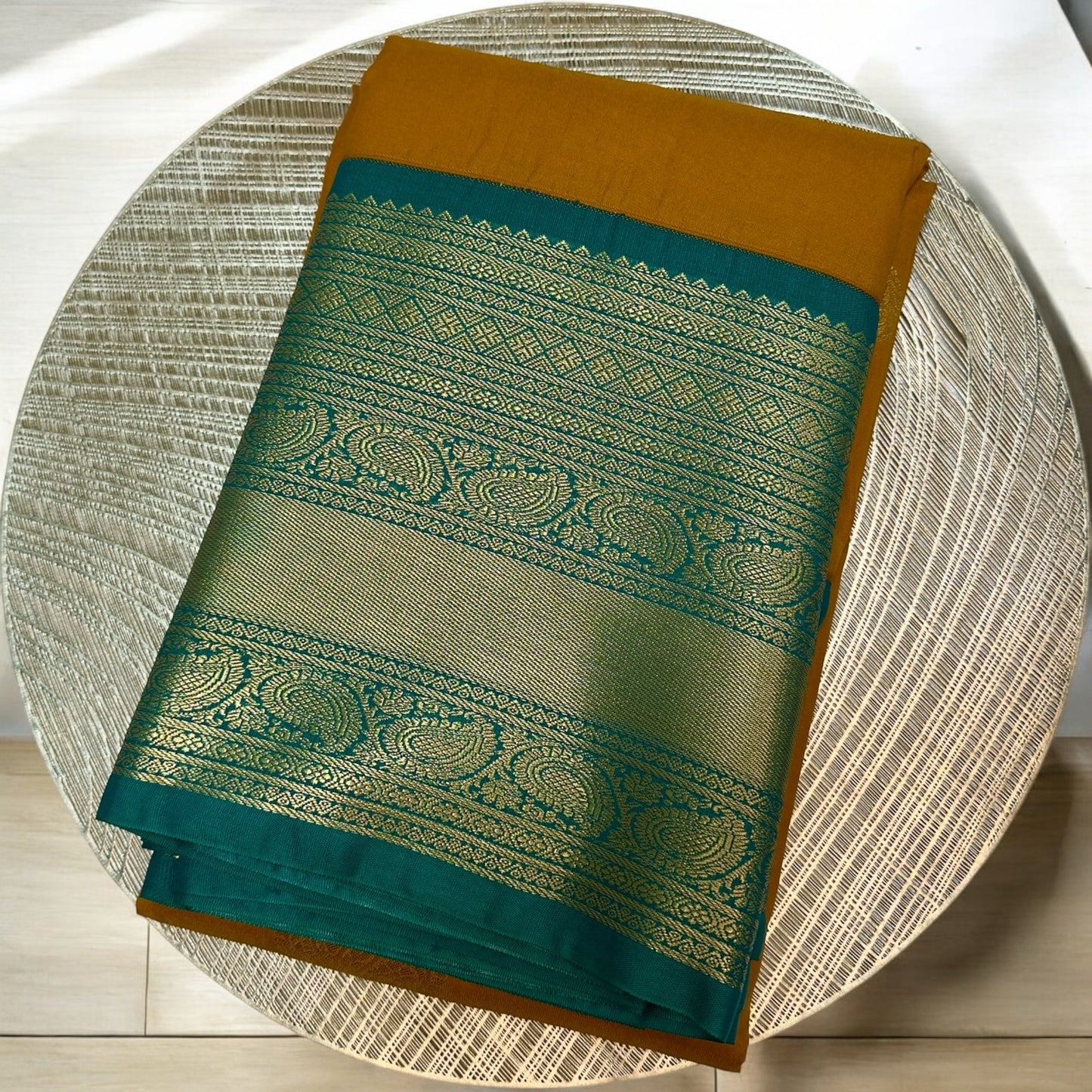 SEMI SILK SAREE – DARK YELLOW WITH SOLID PATTERN AND GREEN BIG GOLDEN BORDER