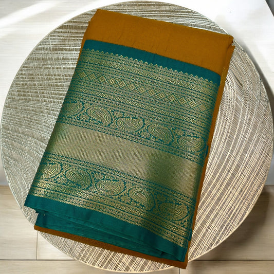 SEMI SILK SAREE – DARK YELLOW WITH SOLID PATTERN AND GREEN BIG GOLDEN BORDER